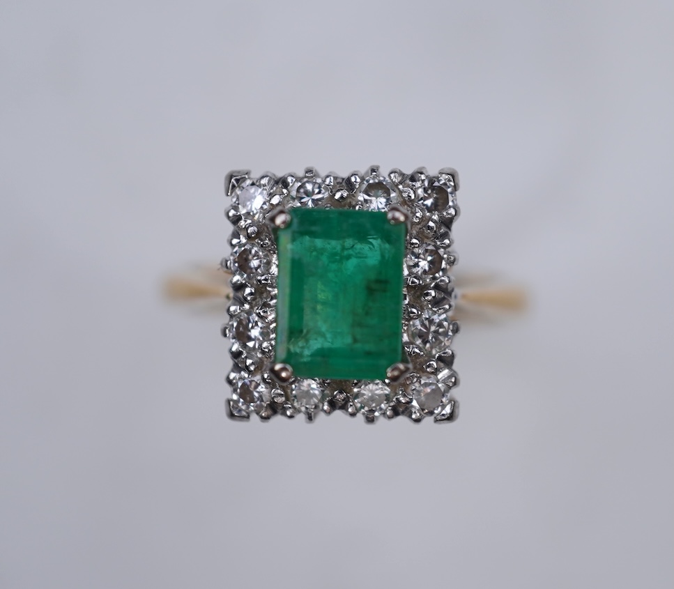 An emerald and diamond ring